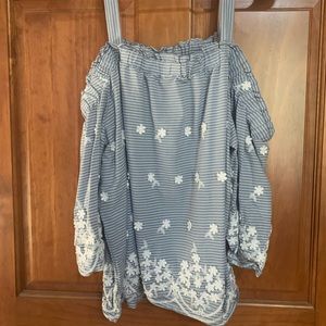 This top is blue and white stripped with little white flowers.